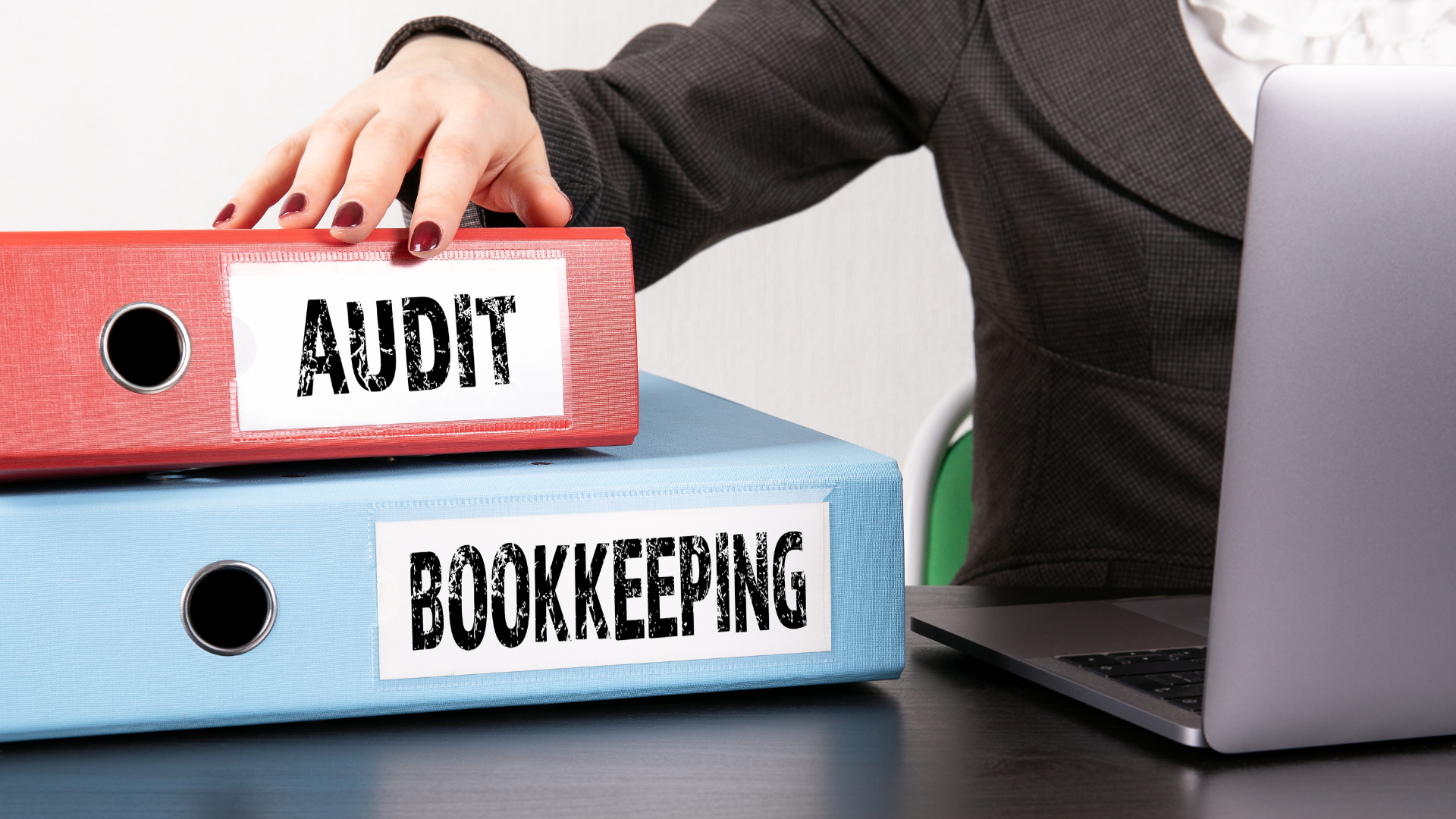 Businesswoman with audit and bookkeeping binders representing signs you have outgrown your accountant